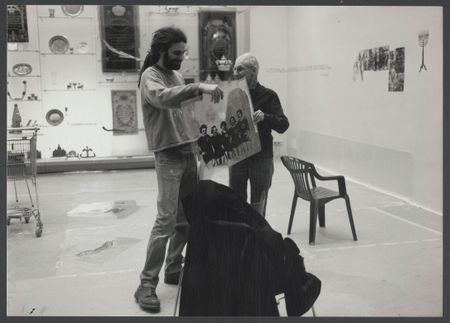 Ein schwarz-weiß Bild von Nancy Spero und einem ihrer Team-Mitglieder beim Besprechen eines Kunstwerks.